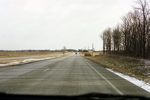 road during daytime, road, highway, way, asphalt, tarmac, trees, film, winter, snow, midwest, 35mm, airfield, airport, runway, city, urban, building, street, town, zebra crossing, transportation, direction, sky, sign, the way forward, road marking, symbol, tree, nature, marking, no people, diminishing perspective, day, plant, mode of transportation, travel, vanishing point, car, outdoors, dividing line, car point of view, treelined, 2K, CC0, public domain, royalty free