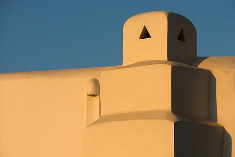 yellow concrete pavement, architecture, nature, outdoors, building, sand, dome, tower, soil, sky, blue, chimney, greece, bulding, spire, steeple, dawn, dusk, sunset, red sky, dune, built structure, clear sky, sunlight, no people, shadow, building exterior, low angle view, wall - building feature, day, yellow, orange color, copy space, shape, wall, 8K, CC0, public domain, royalty free
