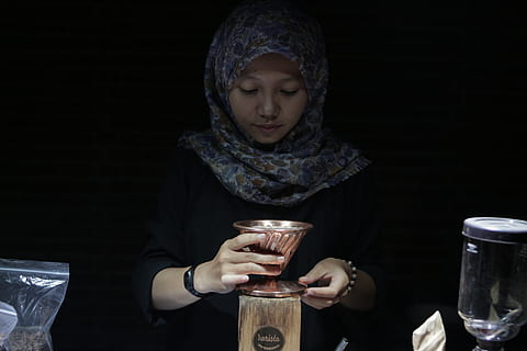 brewing, brew, coffee, drink, caffeine, espresso, breakfast, cup, cafe, barista, beverage, morning, lifestyle, enjoying, aroma, preparation, front view, indoors, one person, holding, real people, food and drink, glass, clothing, refreshment, lifestyles, candle, waist up, looking, black background, looking down, hood, headscarf, burning, warm clothing, hood - clothing, 5K, CC0, public domain, royalty free