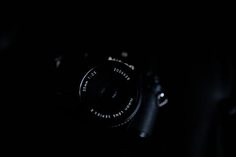 black dslr camera, camera, electronics, camera lens, lens, photography, photo, digital camera, video camera, lens cap, finger, webcam, photographer, fire screen, screen, furniture, silhouette, strap, lock, combination lock, wristwatch, technology, photography themes, indoors, close-up, lens - optical instrument, camera - photographic equipment, photographic equipment, studio shot, lens - eye, black color, number, no people, copy space, selective focus, black background, modern, single object, equipment, slr camera, 5K, CC0, public domain, royalty free