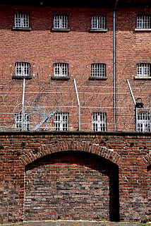 prison, barbed wire, oldenburg, bricks, architecture, built structure, brick, building exterior, brick wall, window, wall, building, no people, arch, day, city, outdoors, wall - building feature, red, old, residential district, communication, the past, history, 4K, CC0, public domain, royalty free