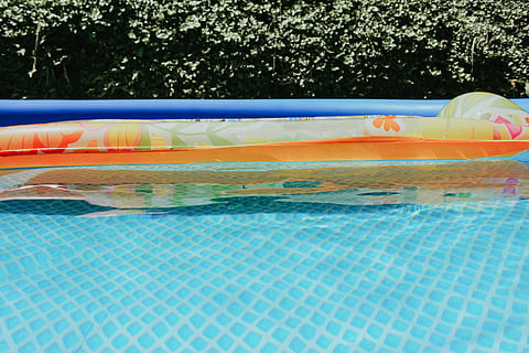 yellow, inflatable ring, pool, boat, dinghy, transportation, vessel, watercraft, tent, water, building, hotel, resort, swimming pool, camping, mountain tent, leisure activities, inflatable, day, nature, floating, floating on water, waterfront, pool raft, no people, outdoors, multi colored, sunlight, blue, tree, relaxation, tubing, tube, turquoise colored, 2K, CC0, public domain, royalty free