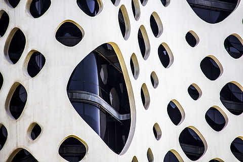 dubai architecture, architecture, full frame, backgrounds, pattern, no people, geometric shape, shape, circle, design, close-up, built structure, day, black color, repetition, metal, wall - building feature, detail, abstract, outdoors, hole, 4K, CC0, public domain, royalty free