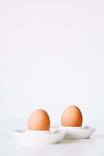 two brown eggshells, egg, food, food and drink, studio shot, healthy eating, copy space, wellbeing, freshness, indoors, no people, white background, raw food, group of objects, still life, medium group of objects, animal egg, fragility, vulnerability, organic, eggcup, boiled egg, egg yolk, breakfast, dieting, 5K, CC0, public domain, royalty free