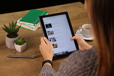 woman, using, tablet computer, computer, electronics, person, human, furniture, pc, lcd screen, display, monitor, screen, table, tabletop, laptop, desk, cup, coffee cup, pottery, surface computer, text, wireless technology, technology, connection, indoors, communication, one person, adult, women, real people, human hand, hand, holding, digital tablet, food and drink, portable information device, lifestyles, high angle view, 5K, CC0, public domain, royalty free