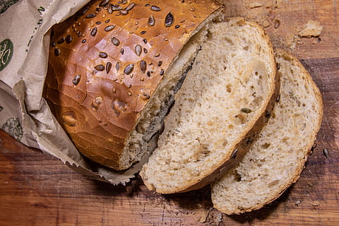 slice of bread, baked, bakery, baking, bread, brown, brown bread, close-up, delicious, eat, food, food photography, from above, healthy, homemade, loaf, paper bag, pastry, seeds, slice, sliced, sunflower seeds, wheat, whole, wooden, food and drink, freshness, indoors, wood - material, table, no people, wellbeing, healthy eating, high angle view, ready-to-eat, directly above, still life, cutting board, group of objects, 5K, CC0, public domain, royalty free