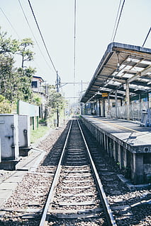 train station, train track, transportation, rail, railway, terminal, vehicle, train, clothing, pants, apparel, construction, subway, jeans, denim, monorail, pedestrian, patio, locomotive, worker, rail transportation, railroad track, track, architecture, built structure, diminishing perspective, sky, building exterior, day, nature, mode of transportation, the way forward, clear sky, direction, no people, cable, building, public transportation, outdoors, electricity, long, 2K, CC0, public domain, royalty free