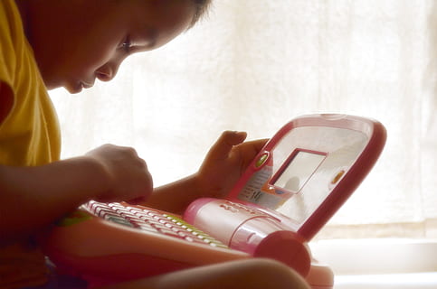 kid playing, academic, computer, education, fun, kids, laptop, learn, people, play, study, toys, technology, one person, holding, wireless technology, indoors, communication, adult, concentration, connection, close-up, day, selective focus, sunlight, looking down, mobile phone, headshot, child, portable information device, 2K, CC0, public domain, royalty free