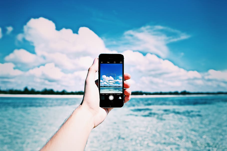 person, holding, black, iphone, beach, cellphone, close-up, cloud, connection, day, device, human, landscape, lifestyles, mobile, ocean, sea, seashore, summer, sun, technology, telephone, touch, tropical, vacation, water, human hand, hand, wireless technology, smart phone, human body part, cloud - sky, portable information device, mobile phone, sky, one person, communication, real people, photography themes, leisure activity, nature, personal perspective, body part, outdoors, finger, 5K
