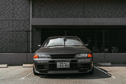 gray vehicle, transportation, automobile, car, vehicle, tire, wheel, machine, car wheel, alloy wheel, spoke, sports car, coupe, license plate, asphalt, tarmac, road, text, label, light, headlight, mode of transportation, city, motor vehicle, architecture, built structure, land vehicle, building exterior, street, day, no people, outdoors, building, parking lot, motion, on the move, stationary, sunlight, garage, 4K, CC0, public domain, royalty free