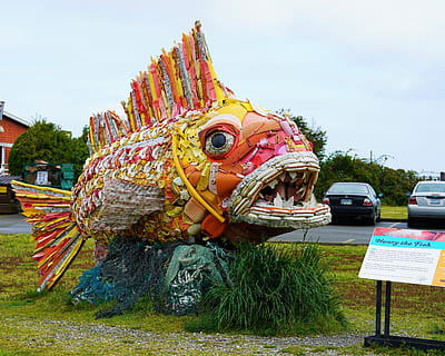 multicolored fish statue, automobile, transportation, vehicle, car, grass, plant, crowd, festival, theme park, amusement park, dragon, tire, inflatable, lawn, toy, pinata, outdoors, figurine, park, clothing, representation, art and craft, creativity, sculpture, sky, day, nature, statue, craft, multi colored, no people, architecture, belief, human representation, built structure, mode of transportation, 5K, CC0, public domain, royalty free