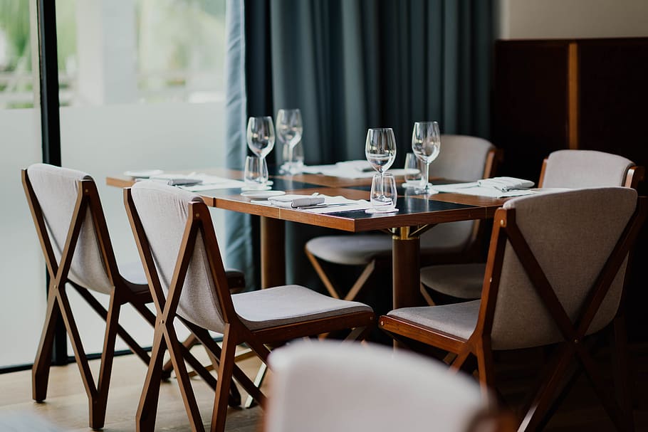 table, chair, seat, absence, furniture, business, restaurant, empty, no people, glass, place setting, setting, indoors, household equipment, food and drink, drinking glass, wineglass, tablecloth, arrangement, dining table, crockery, 5K