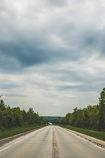 empty, blacktop road, cloudy, sky, asphalt, cloud, countryside, dramatic, dramatic sky, guidance, highway, landscape, off-road, outdoors, paved road, perspective, road, roadtrip, roadway, rural, travel, tree, direction, the way forward, cloud - sky, diminishing perspective, transportation, plant, sign, symbol, nature, day, no people, road marking, beauty in nature, marking, vanishing point, empty road, long, dividing line, 2K, CC0, public domain, royalty free
