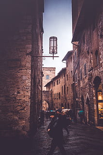 architecture, building, infrastructure, structure, establishment, apartment, windows, people, walking, rain, umbrella, store, shop, built structure, building exterior, real people, lifestyles, one person, city, residential district, street, rear view, lighting equipment, day, standing, full length, direction, nature, women, outdoors, alley, 4K, CC0, public domain, royalty free