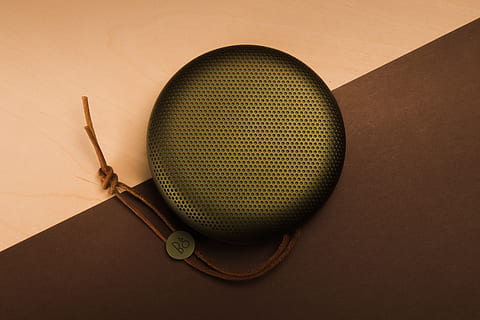 black portable speaker, sphere, speaker, green, diagonal, play, design, angles, contrast, product photography, product, studip photography, leather, technology, bluetooth, speakers, ghettoblaster, studio, bang olufsen, bando, slick, colored background, indoors, no people, ball, studio shot, wood - material, sport, close-up, high angle view, brown, brown background, still life, directly above, two objects, sports equipment, simplicity, single object, yellow, table, orange background, 5K, CC0, public domain, royalty free