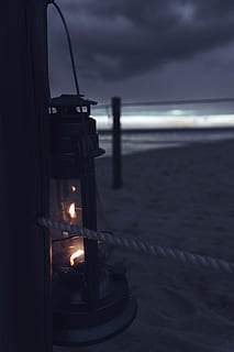 gray, lantern, window, sky, flame, cloud - sky, burning, sea, nature, fire, land, water, beach, fire - natural phenomenon, illuminated, heat - temperature, no people, candle, dusk, sand, lighting equipment, oil lamp, close-up, dark, horizon over water, electric lamp, 5K, CC0, public domain, royalty free