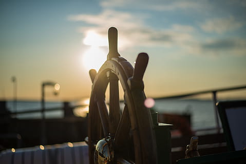 still, items, things, stirring, wheel, boat, yacht, reflection, nature, water, ocean, sea, sky, clouds, sun, light, leaks, bokeh, travel, transportation, sunset, focus on foreground, sunlight, no people, mode of transportation, cloud - sky, close-up, outdoors, technology, lens flare, wood - material, architecture, 5K, CC0, public domain, royalty free