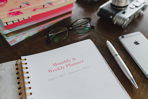 pink calendar, calendar, notebook, diary, note, desk, note pad, pen, glasses, table, paper, no people, indoors, eyeglasses, spiral notebook, pencil, text, book, high angle view, document, publication, close-up, writing instrument, handwriting, education, list, to do list, 5K, CC0, public domain, royalty free