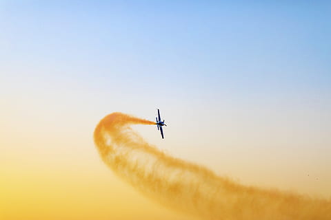 black, airplane, sky, aeroplane, aircraft, clouds, colors, daylight, flight, flying, plane, sun, wings, air vehicle, mode of transportation, transportation, on the move, low angle view, mid-air, travel, motion, nature, airshow, no people, clear sky, copy space, vapor trail, fighter plane, speed, outdoors, aerobatics, 5K