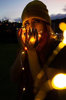 woman, holding, string lights, evening, lights, standing, one person, looking at camera, illuminated, portrait, real people, lifestyles, front view, waist up, young adult, leisure activity, night, young women, women, lighting equipment, lens flare, nature, casual clothing, beautiful woman, outdoors, hairstyle, light, teenager, 5K, CC0, public domain, royalty free