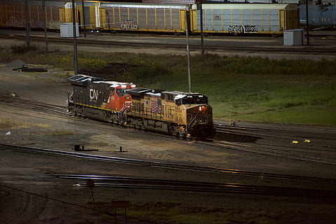 yellow train, train, vehicle, transportation, united states, north platte, railway, train track, rail, freight car, shipping container, motor, engine, machine, tarmac, asphalt, race car, sports car, car, automobile, dirt road, mode of transportation, rail transportation, track, land vehicle, railroad track, public transportation, train - vehicle, no people, day, road, outdoors, business, travel, motion, nature, freight transportation, passenger train, city, railroad car, shunting yard, station, 5K, CC0, public domain, royalty free