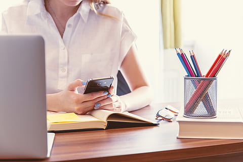 young, woman typing message, smartphone, home office, wireless technology, technology, table, connection, one person, adult, communication, business, holding, indoors, finance, credit card, women, sitting, furniture, internet, computer, portability, paying, 5K
