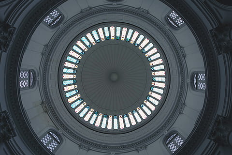 architecture, building, window, tower, clock tower, skylight, circle, symmetry, abstract, top, wristwatch, apse, pillar, column, vault ceiling, arched, arch, dome, assembly line, factory, built structure, low angle view, indoors, no people, geometric shape, shape, ceiling, cupola, pattern, design, directly below, day, architectural feature, sunlight, ornate, architecture and art, government, 5K, CC0, public domain, royalty free