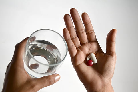 glass, water, medicine, doctor, health, hospital, human hand, human body part, hand, holding, one person, studio shot, white background, indoors, adult, close-up, household equipment, body part, dose, pill, drinking glass, healthcare and medicine, cut out, finger, 2K