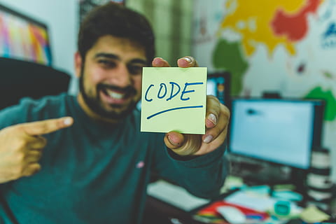 man, grey, sweater, holding, yellow, sticky, note, code, coding, macro, programmer, programming, sticky note, one person, young adult, front view, communication, young men, indoors, focus on foreground, casual clothing, men, text, portrait, showing, smiling, real people, western script, emotion, facial hair, waist up, message, 5K, CC0, public domain, royalty free