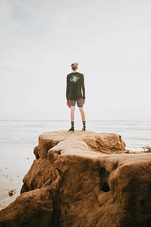 person, standing, edge, cliff, front, ocean, daytime, beach, dude, teeb, confident, one person, rock, water, full length, rock - object, sea, lifestyles, real people, solid, land, leisure activity, nature, beauty in nature, rear view, sky, day, outdoors, looking at view, 5K, CC0, public domain, royalty free