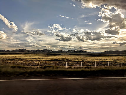 panorama photography, landscape, clouds, daytime, field, grass, mountains, nature, road, sky, cloud - sky, mountain, environment, tranquil scene, scenics - nature, beauty in nature, tranquility, no people, land, mountain range, day, non-urban scene, idyllic, sunlight, agriculture, outdoors, 4K, CC0, public domain, royalty free