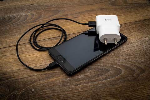two pin, two pin plug, accessories, accessory, adapter, cable, cellphone, charge, charger, charging, drive, mobile phone charger, network, phone, phone charger, pin, plastic, plug, port, portable, portable 2 pin, smartphone, usb, usb cable, usb charger, technology, table, wireless technology, wood - material, connection, high angle view, communication, no people, portable information device, smart phone, still life, black color, mobile phone, indoors, close-up, listening, white color, headphones, directly above, personal accessory, 5K, CC0, public domain, royalty free