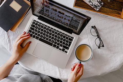 woman works, desk, laptop, cup, coffee, macbook, computer, work, study, home office, office, technology, cappucino, late, workspace, workplace, wireless technology, adult, furniture, communication, connection, human body part, using laptop, indoors, high angle view, one person, human hand, drink, food and drink, keyboard, hand, 5K