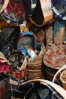 assorted textiles, apparel, clothing, cat, mammal, animal, pet, basket, helmet, crash helmet, boot, footwear, accessories, accessory, bag, handbag, market, rust, purse, hardhat, bazaar, for sale, retail, choice, no people, large group of objects, variation, market stall, container, day, business, abundance, high angle view, outdoors, multi colored, small business, retail display, full frame, sale, street market, 4K, CC0, public domain, royalty free