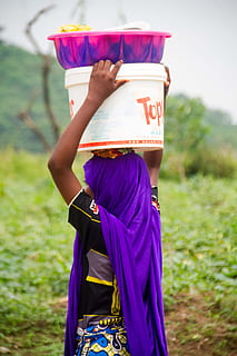 model, woman, hijab, topper, hawk, hawker, lady, nigeria, nigerian, african, africa, black, bowls, one person, real people, focus on foreground, women, holding, lifestyles, grass, leisure activity, field, land, day, clothing, traditional clothing, plant, adult, midsection, three quarter length, nature, child, outdoors, purple, obscured face, 5K, CC0, public domain, royalty free