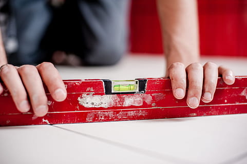 level, construction, repairs, renovations, safety, architect, worker, hands, floors, house, home, red, human hand, hand, human body part, one person, close-up, indoors, table, leisure activity, men, occupation, focus on foreground, toy, real people, lifestyles, wood - material, day, craft, finger, 4K, CC0, public domain, royalty free