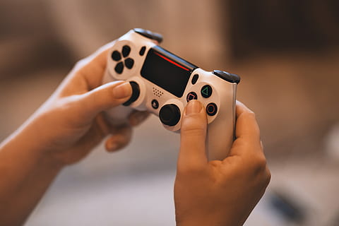 person, holding, sony ps 4 controller, ps4, action, activity, device, fun, game, gaming, hand, leisure, play, players, playstation, recreation, technology, human hand, human body part, one person, focus on foreground, close-up, arts culture and entertainment, indoors, playing, offspring, leisure activity, body part, childhood, adult, nail polish, child, music, finger, human limb, 5K, CC0, public domain, royalty free