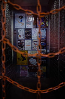 human, person, shelf, contemporary, trapped, room, urban, posters, downtown, chains, market, wallpaper, street, seattle, phone wallpaper, advertisement, poster, arcade game machine, collage, brochure, communication, text, fence, no people, metal, barrier, boundary, technology, night, safety, connection, chainlink fence, security, indoors, western script, telephone, close-up, illuminated, focus on background, 5K, CC0, public domain, royalty free