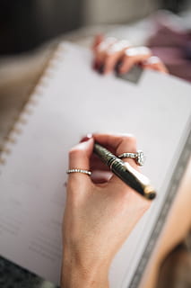 writing, notebook, lying, bed, coffee, candles, gingerbreads, female, girl, woman, workspace, work, hand, organizer, calendar, cosy, cozy, planning, human hand, one person, human body part, close-up, holding, paper, indoors, selective focus, book, publication, pen, women, adult, high angle view, table, accuracy, focus on foreground, finger, human limb, 5K