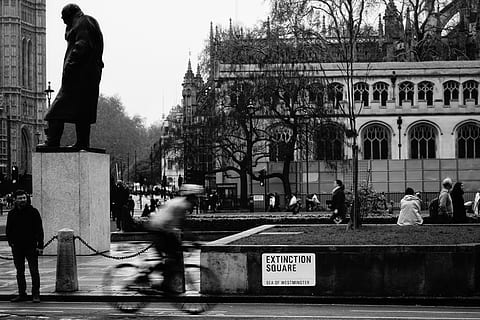 extinction square, person, human, pedestrian, building, architecture, urban, downtown, city, town, spire, tower, steeple, transportation, vehicle, sculpture, statue, art, bicycle, bike, sport, real people, built structure, building exterior, men, group of people, blurred motion, street, people, lifestyles, motion, day, women, adult, city life, nature, travel, outdoors, 5K, CC0, public domain, royalty free