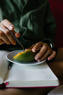 mango, hands, notebook, one person, holding, indoors, human hand, real people, hand, front view, food and drink, midsection, food, focus on foreground, freshness, human body part, close-up, table, eating utensil, adult, lifestyles, wellbeing, finger, 4K, CC0, public domain, royalty free