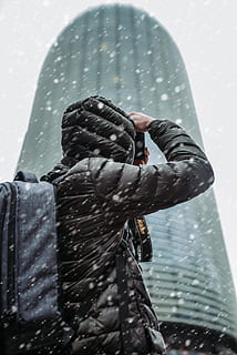 persona, indossare, giacca invernale, nevicando, architettura, zaino, costruzione, telecamera, freddo, dispositivo, elettronica, moderno, nikon, fotografo, stagione, schiocco, la neve, nevoso, scattare foto, scattare una foto, tecnologia, tempo metereologico, inverno, Abbigliamento invernale, persone reali, persone, capi di abbigliamento, Fotografare, detenzione, attività di svago, acqua, stili di vita, attività, bagnato, giorno, vestiti caldi, natura, uomini, retrovisore, temi fotografici, pioggia, all'aperto, stagione piovosa, cappuccio - abbigliamento, Camera digitale, 5K, CC0, dominio pubblico, privo di copyright