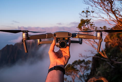 gray drone, person, human, photography, photo, camera, plant, photographer, gun, weapon, weaponry, sky, nature, propeller, machine, vacation, quad, pro, mavic pro, innovation, control, holding, hand, human hand, real people, human body part, one person, tree, men, orange color, lifestyles, photography themes, technology, personal perspective, focus on foreground, outdoors, leisure activity, finger, 4K, CC0, public domain, royalty free
