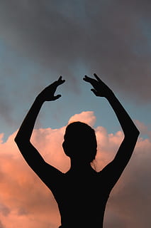 silhouette, ballet dancer, backlit, dance, dancer, dancing, dawn, female, dom, girl, person, sunrise, sunset, wellbeing, woman, sky, human arm, lifestyles, one person, arms raised, leisure activity, real people, cloud - sky, women, adult, rear view, standing, orange color, nature, waist up, beauty in nature, headshot, positive emotion, hand raised, 4K, CC0, public domain, royalty free