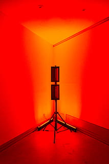 zwart torenlicht, statief, hoek, muur, LCD scherm, scherm, monitor, elektronica, tonen, licht, verlichting, antenne, elektrisch apparaat, kapstok, microfoon, pc, computer, laptop, wandklok, klok, projectiescherm, binnenshuis, Oranje kleur, rood, ingebouwde structuur, muur - bouwfunctie, architectuur, geen mensen, leeg, afwezigheid, kunst cultuur en entertainment, verlicht, levendige kleuren, bevloering, verlichtingsapparatuur, huiskamer, communicatie, dag, stoel, plafond, 5K, CC0, publiek domein, royaltyvrij