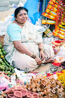sitting woman outdoor, bargain, bazaar, Booth, commerce, culture, daylight, indian, indian festival, market, marketplace, merchant, option, outdoors, person, sale, sell, shop, shopping, stall, stock, store, street, traditional, wear, woman, food, real people, women, adult, business, retail, selling, food and drink, people, occupation, market stall, lifestyles, small business, smiling, females, mature adult, men, 4K, CC0, public domain, royalty free