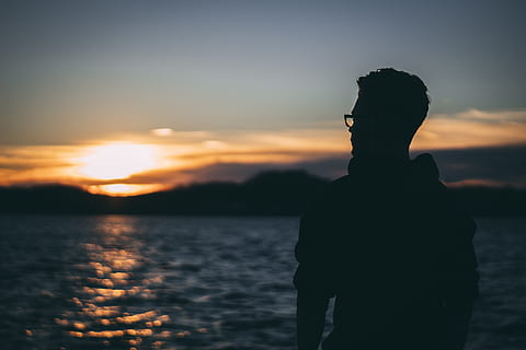 silhouette, man, sunrise, backlit, beach, clouds, evening, eyewear, landscape, mountains, ocean, person, sea, seascape, seashore, sky, sun, sunset, water, waves, real people, beauty in nature, leisure activity, scenics - nature, standing, one person, lifestyles, tranquility, men, nature, orange color, tranquil scene, outdoors, 5K, CC0, public domain, royalty free