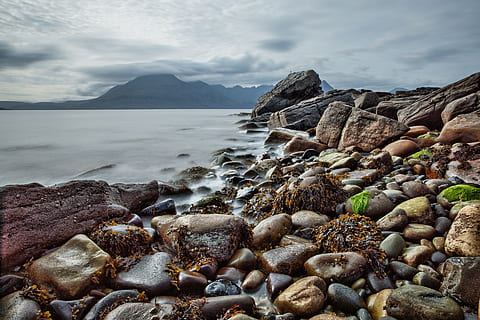 brown, black, gray, rocks, shore, clouds, mountain, ocean, sea, seascape, seashore, seaweeds, water, rock, solid, rock - object, beauty in nature, scenics - nature, cloud - sky, beach, sky, land, tranquility, nature, stone, tranquil scene, day, no people, pebble, rocky coastline, 1080P, CC0, public domain, royalty free