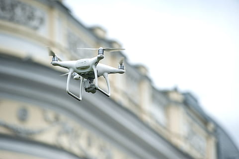 white drone quadcopter, camera, drone, flying, macro, quadcopter, technology, selective focus, low angle view, no people, day, architecture, focus on foreground, security, close-up, safety, built structure, outdoors, protection, nature, white color, building exterior, surveillance, faucet, motion, security camera, 4K, CC0, public domain, royalty free