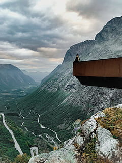 man, sitting, edge, stone, clouds, daylight, daytime, high, landscape, mountain peak, mountains, nature, outdoors, person, rocks, scenic, view, mountain, cloud - sky, sky, scenics - nature, beauty in nature, mountain range, tranquil scene, tranquility, non-urban scene, environment, day, rock, idyllic, solid, rock - object, remote, formation, 4K, CC0, public domain, royalty free